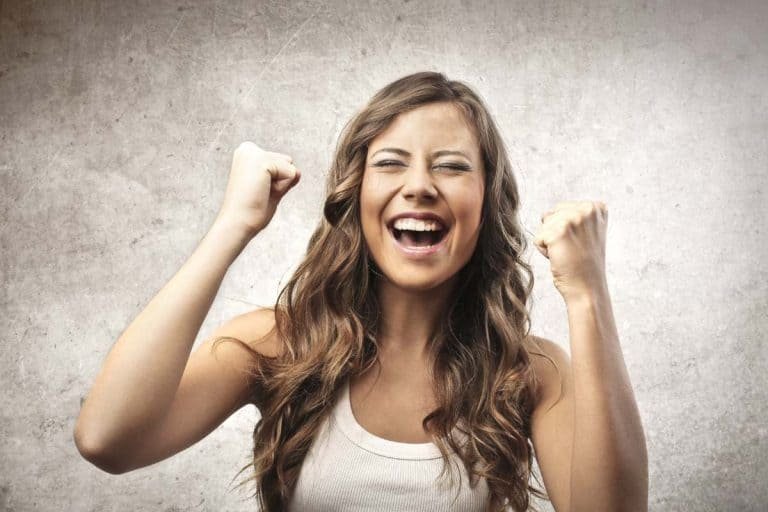 a woman with her arms up and her mouth open